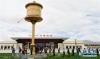 6月17日，游客经过日喀则火车站广场。