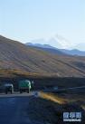 老杨驾驶货车（左二）行驶在318国道定日县境内，远处是珠穆朗玛峰（10月28日摄）。