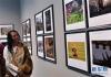 12月6日，一名藏族摄影师在青海省美术馆内观看摄影展。