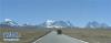 通向日喀则市聂拉木县的公路及远处的山峰（12月9日摄）。