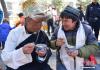 藏族的边角（左）与维吾尔族的阿卜杜力艾则同吃“古突”。 中新社记者 何蓬磊 摄