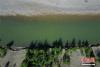 6月6日，正值初夏时节，318国道川藏线西藏左贡县境内，玉曲河从远处雪山缓缓流下，与郁郁葱葱的树林构成一幅美丽画卷。 张浪 摄