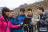 中国科学院成都山地灾害与环境研究所科研人员李秀珍、杨宗佶、李战鲁、陈晓清、游勇（从左至右）在西藏自治区八宿县白玛镇旺北村滑坡现场考察，检查探测到的数据（6月25日摄）。