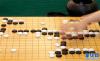 7月7日，西藏队选手金秋彤在与青海队选手刘欣悦在围棋决赛业余团体第六轮比赛中落子。