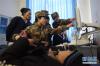 在青海省玉树藏族自治州称多县歇武镇中心卫生院，解放军第107医院特检科专家张艳梅（左二）对当地群众进行包虫病检查（2017年11月11日摄）。 新华社记者张宏祥摄