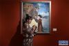 12月28日，在广州艺术博物院，一名在广州读书的藏族女孩与自己喜欢的绘画作品合影留念。新华社记者 梁旭 摄