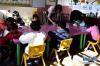 在门源县东川镇尕牧龙上村的幼儿园内，老师在指导孩子们写字（10月25日摄）。新华社发（张龙摄）