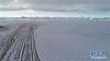 冰封的纳木错在雪山环绕下美轮美奂（1月17日无人机拍摄）。冰封的冬季纳木错，静静地依偎在雪山的怀抱中，相互陪伴共度寒冬。新华社记者 普布扎西 摄