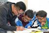 5月7日，在山南市第一高级中学，来自湖北省宜昌市秭归一中的援藏老师宋成（左）为高三学生辅导功课。 