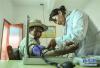 嘎宗卓玛（右）在卫生室给乡亲检查身体（8月3日摄）。