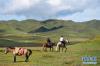 8月13日，游客在甘南藏族自治州碌曲县尕海镇尕秀村草原上骑马。 新华社记者 赵丁喆 摄