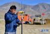 3月1日，在西藏日喀则市桑珠孜区曲美乡那塘村，测绘人员平措在高标准农田项目施工现场进行测量。
