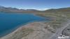 在西藏自治区的错那县，有一处澄澈的湖泊，浪涌着一下一下拍打着岸边的碎石，深蓝色的湖面如同天空翻转下来。抬眼望去，四周是白雪皑皑的高山，各色野花点点散落在草甸。它叫拿日雍错，意为“湖的前面”。