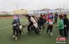 9月10日，青海省海南藏族自治州同德县贡麻小学，教师刘秀青和孩子们在操场玩游戏。