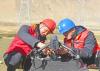 2020年12月14日，安徽省电力有限公司援藏帮扶技术人员在指导西藏自治区山南供电公司工作人员进行`四旋翼无人飞机`线路巡检前安装检查。(宋卫星摄/光明图片)