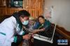 3月14日，幸福敬老院医务室医生土丁西周（左）为老人测量血压。