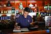 在拉萨市墨竹工卡县，洛桑益西在自己开的藏餐店内算账（6月23日摄）。新华社记者 姜帆 摄