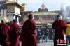 1月12日，西藏拉萨，来自青海玉树的僧人们正在大昭寺前准备合影留念。 李林 摄