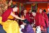 图为6月12日，班禅在西藏昌都强巴林寺为信众摸顶赐福。